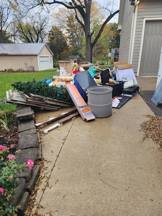 Dumpster being loaded with debris for 12 Yard Dumpster Rental in Blaine